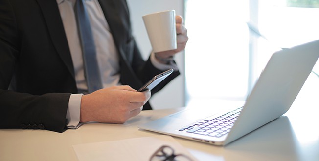 The Louie | Business center | Guy with computer phone and coffee